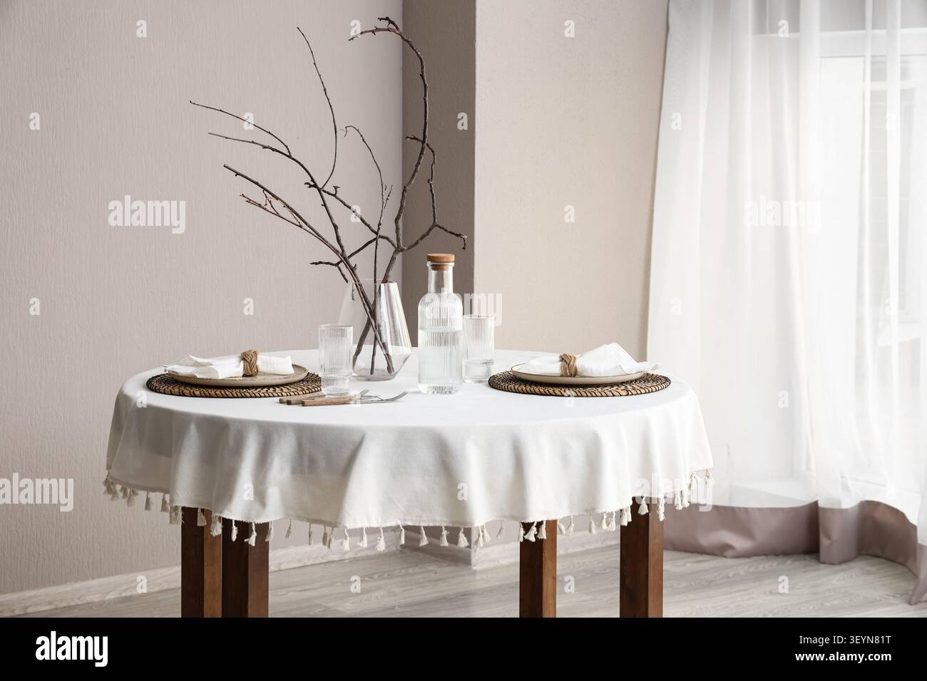 Minimalist dining table set for two with natural decor Stock Photo