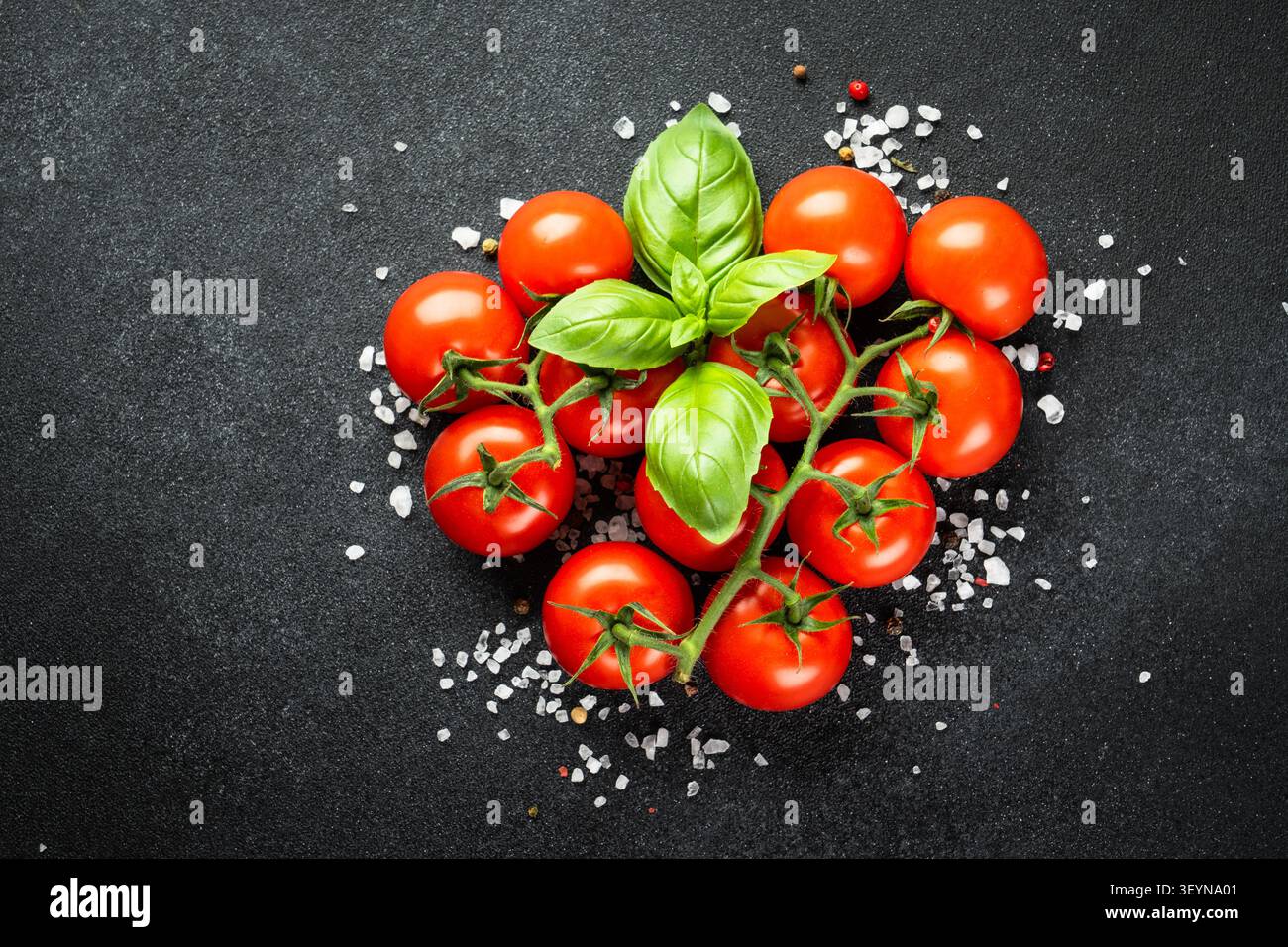 Cherry tomatoes on black table. Stock Photo