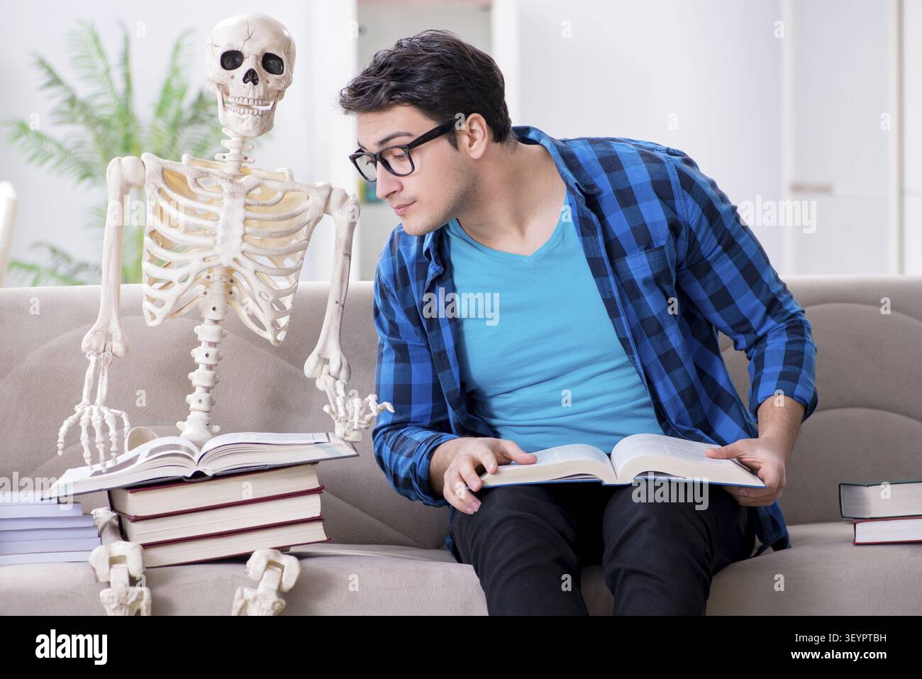Student studying with skeleton preparing for exams Stock Photo