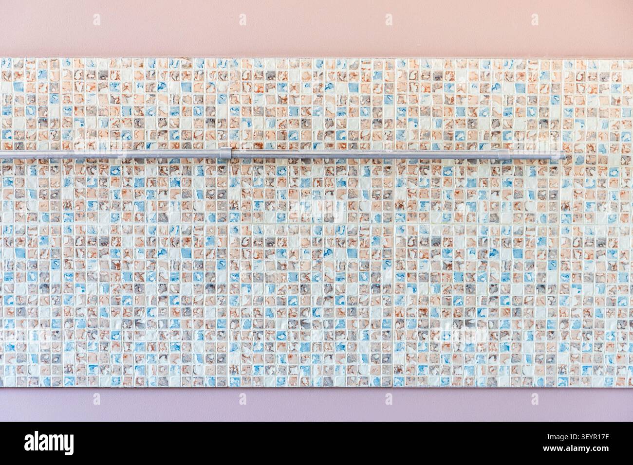 mosaic wall panel with railing on pink kitchen wall during home renovation Stock Photo