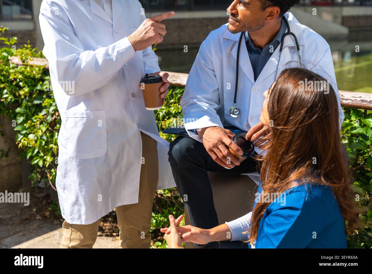 Medical professional team collaborating outdoors sharing ideas Stock Photo