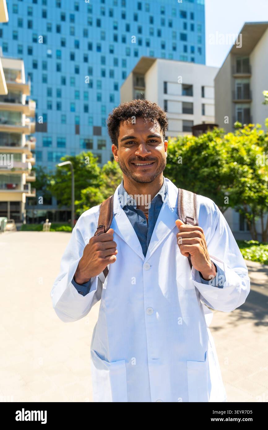 Young black student wearing a lab coat and backpack Stock Photo