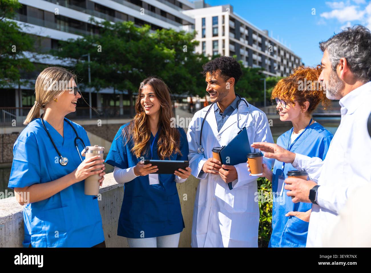 Medical team collaborating and sharing ideas outdoors Stock Photo