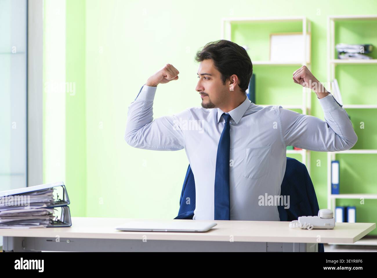 Employee doing exercises during break at work Stock Photo