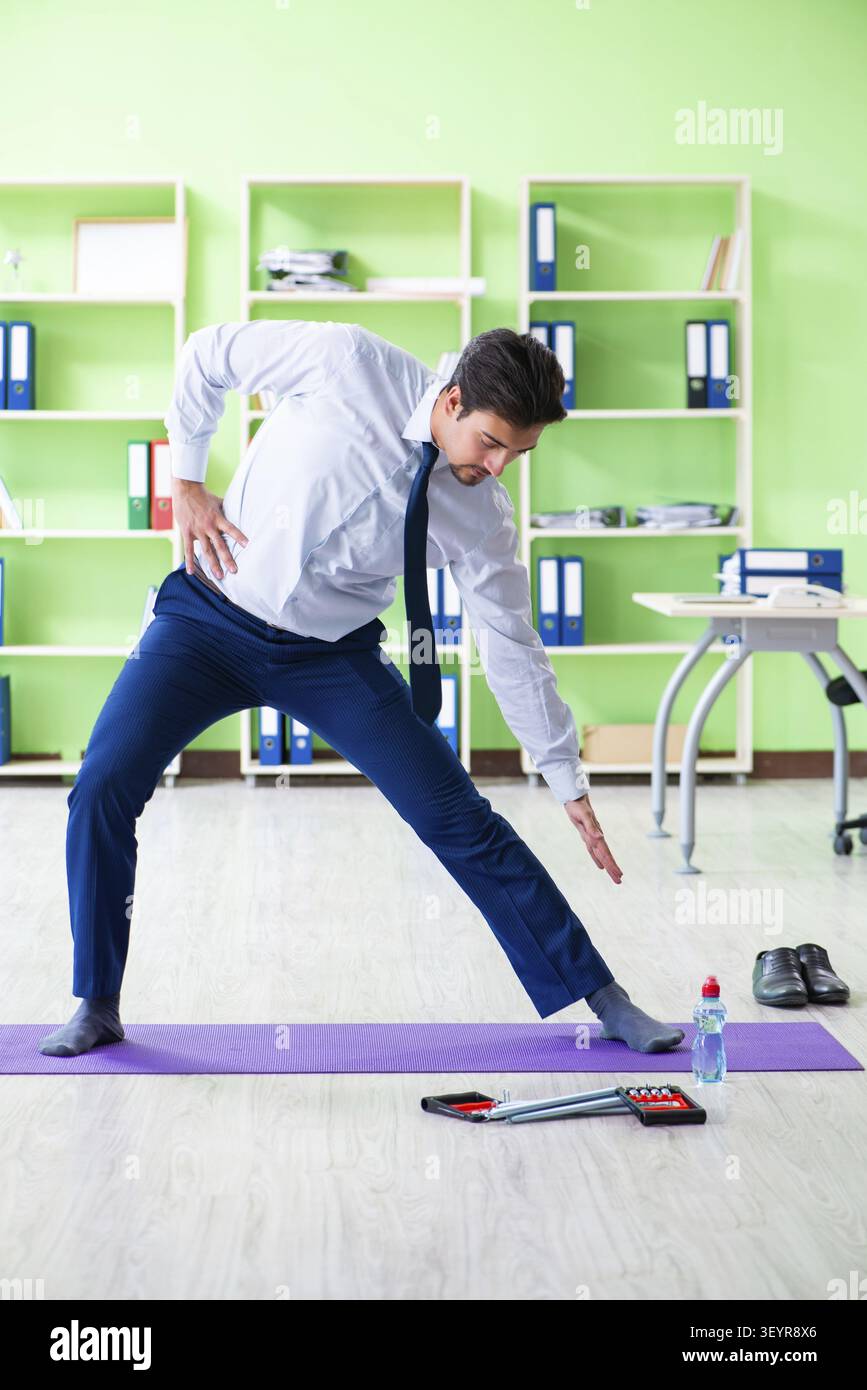 Employee doing exercises during break at work Stock Photo