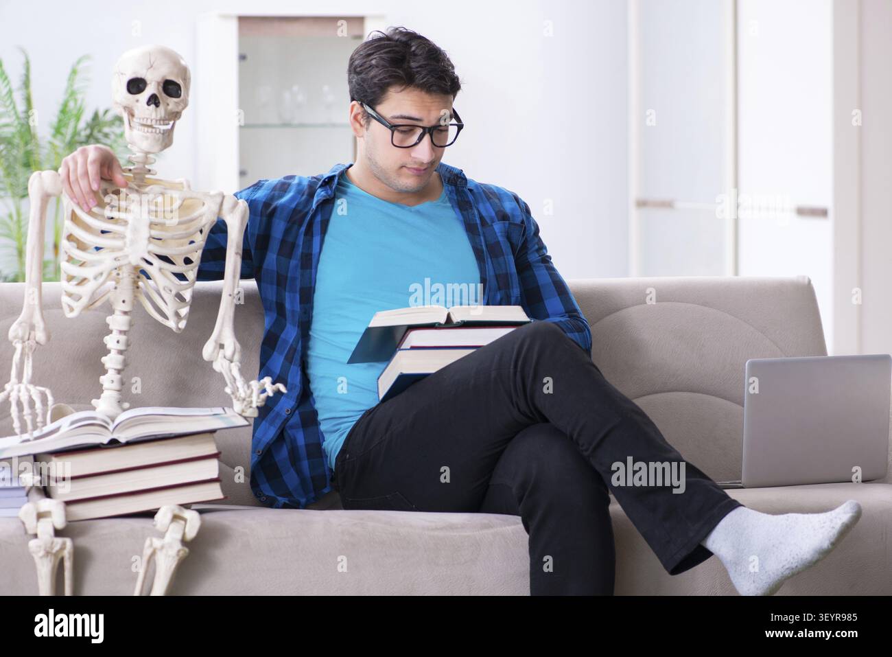 Student studying with skeleton preparing for exams Stock Photo