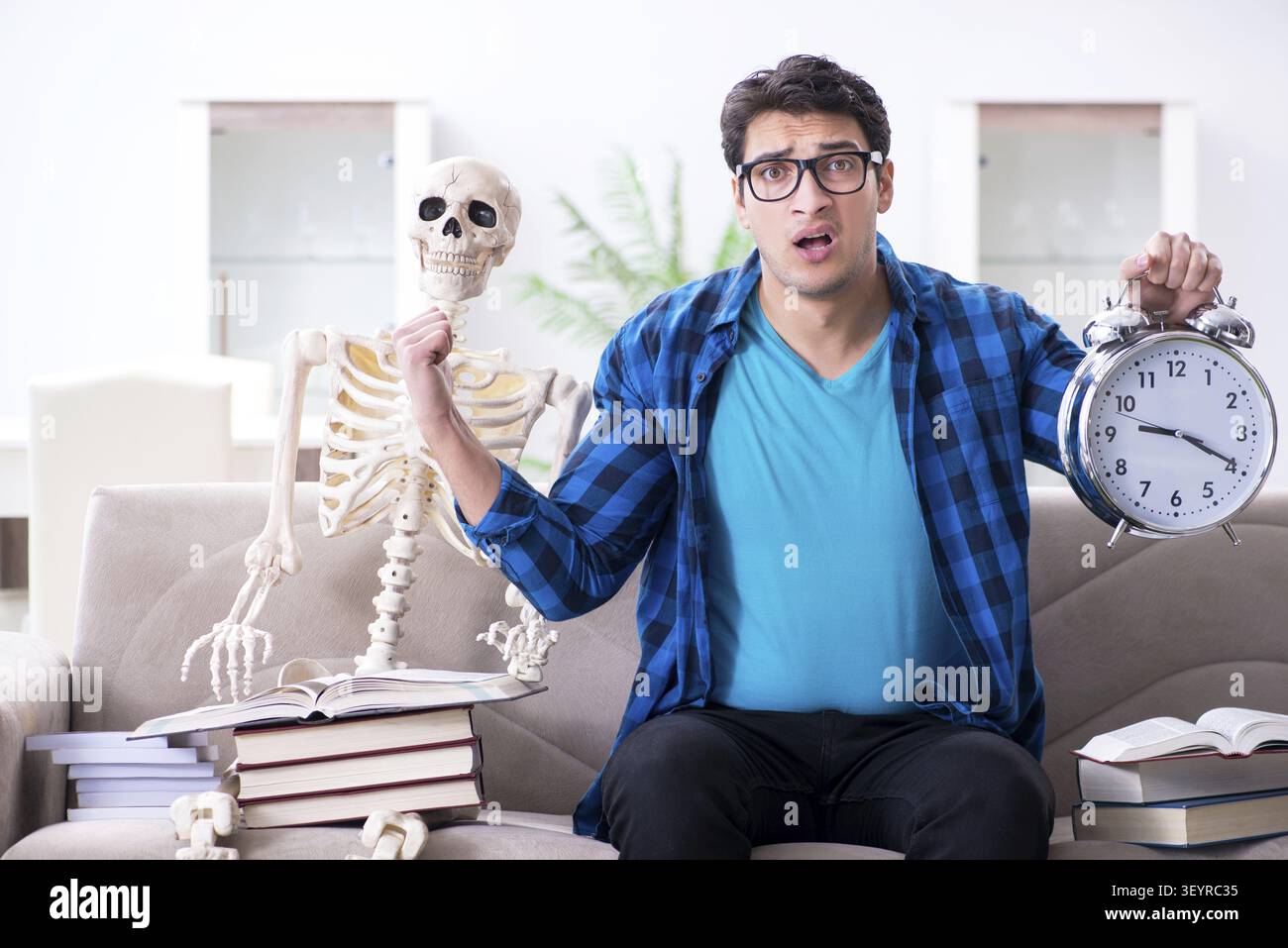 Student studying with skeleton preparing for exams Stock Photo