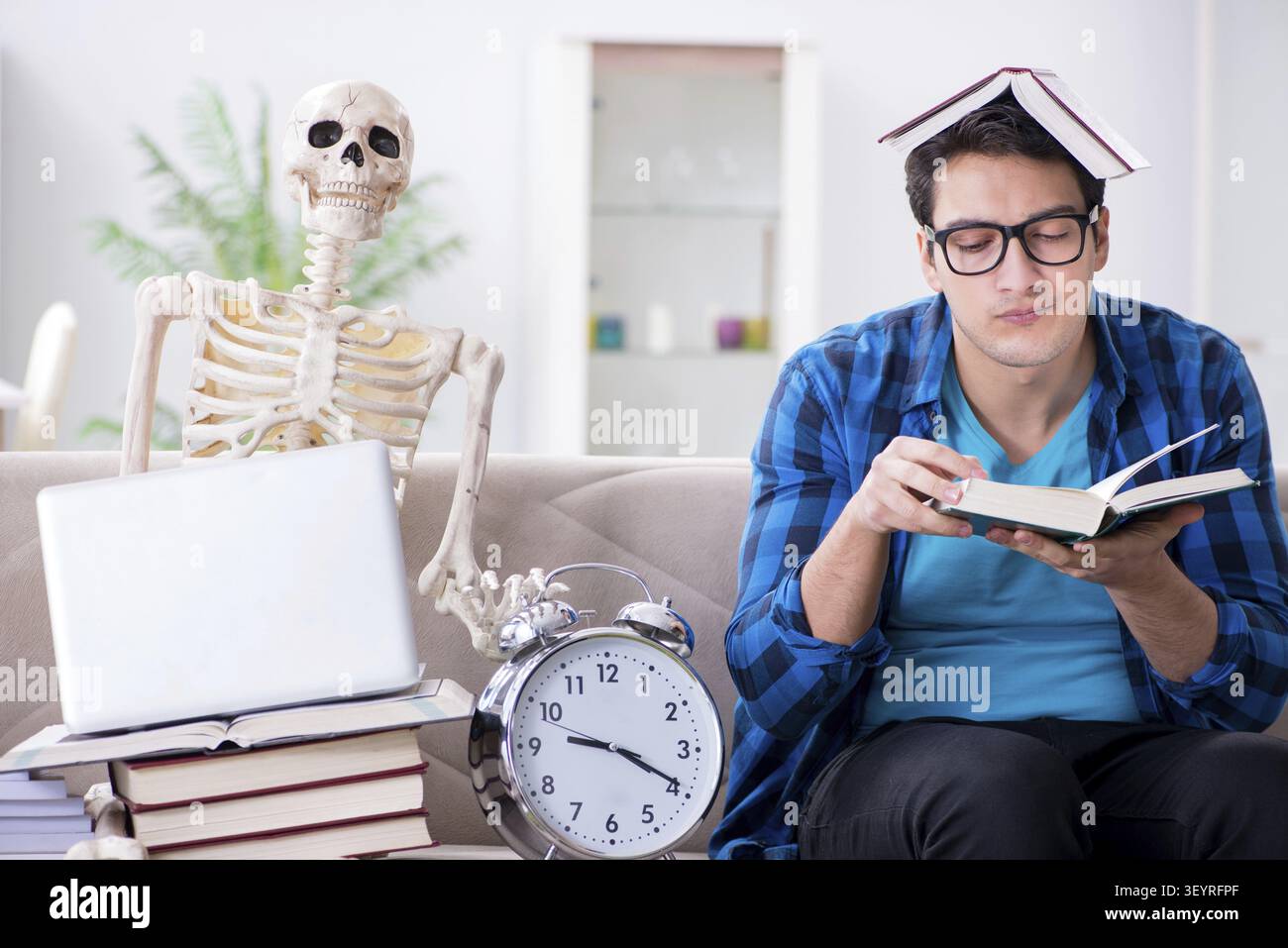 Student studying with skeleton preparing for exams Stock Photo