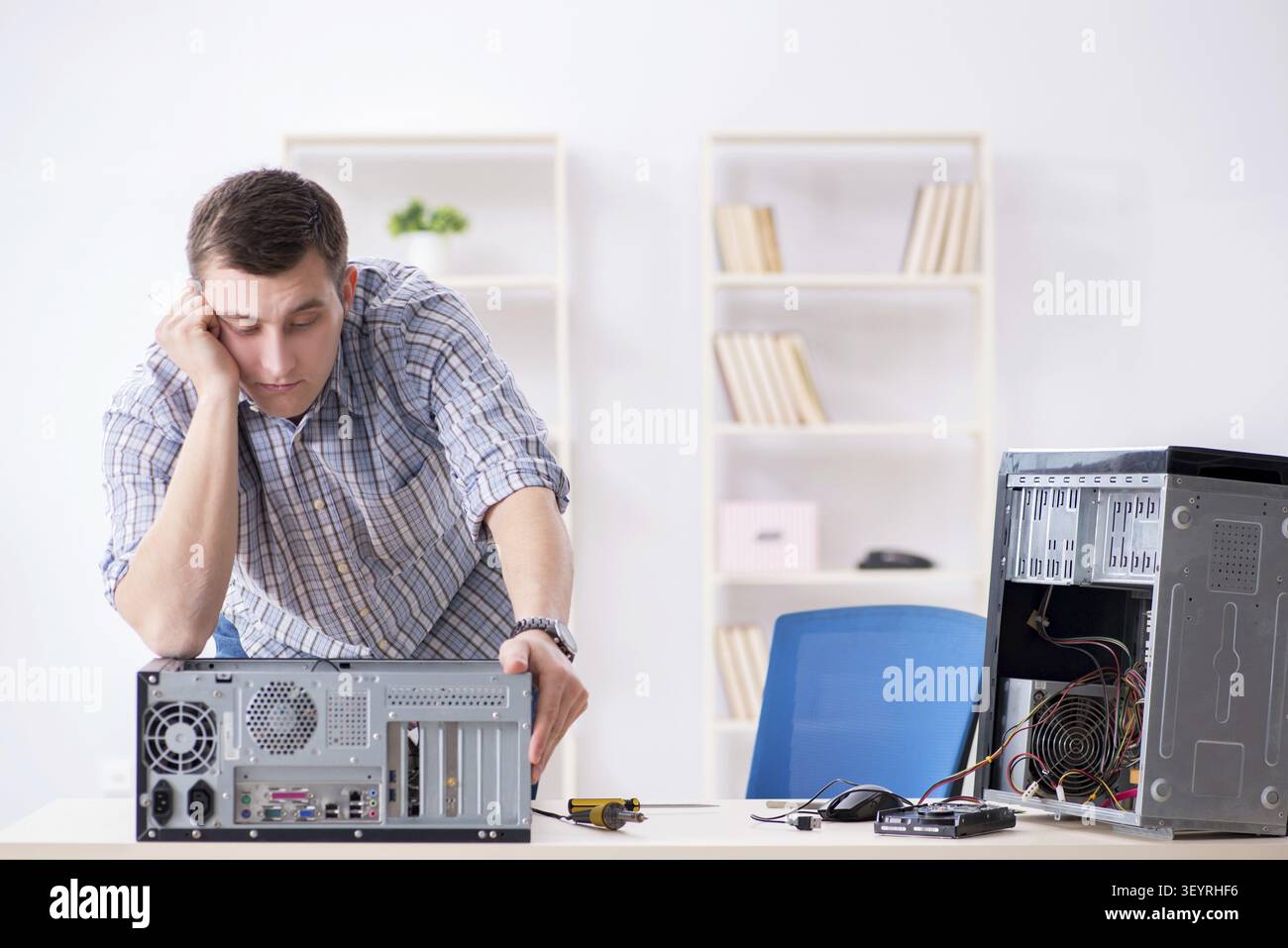 Young technician repairing computer in workshop Stock Photo