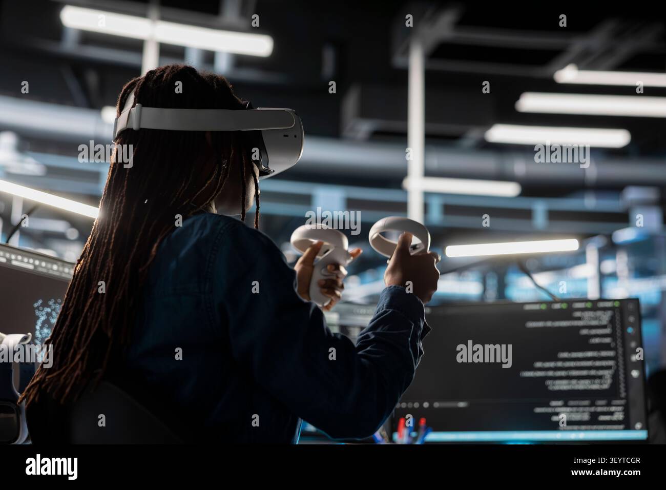 Server facility computing specialist programming equipment working with virtual reality technology. Server environment IT expert working with VR headset tech to update AI systems. Stock Photo