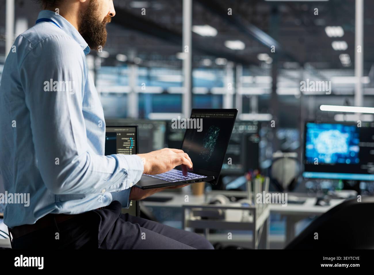 Data center programmer reviews artificial intelligence systems and machine learning processes inside a data center. Stock Photo