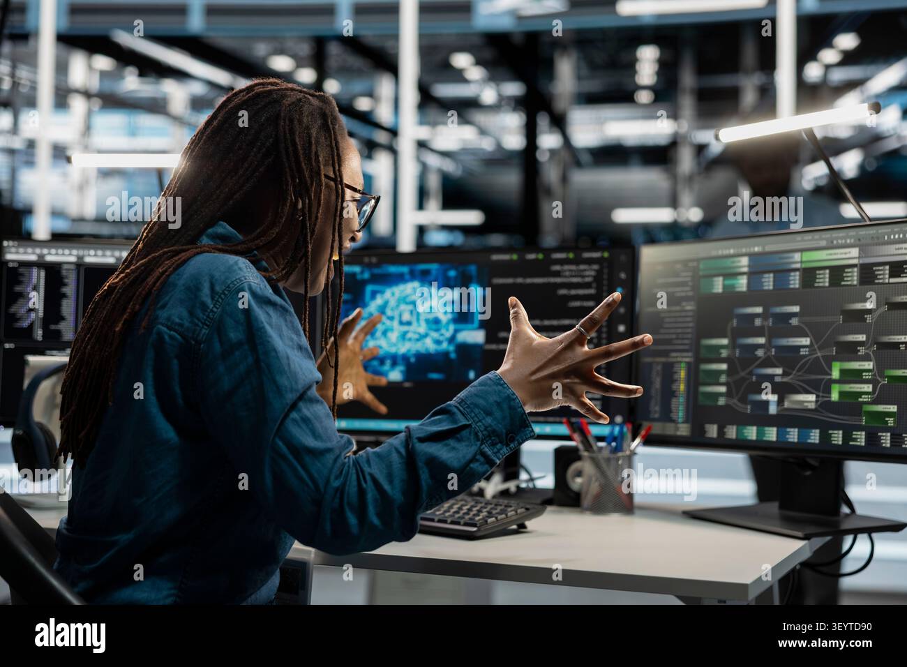 Delighted admin celebrates progress after making data center equipment run artificial intelligence and machine learning tools. Stock Photo