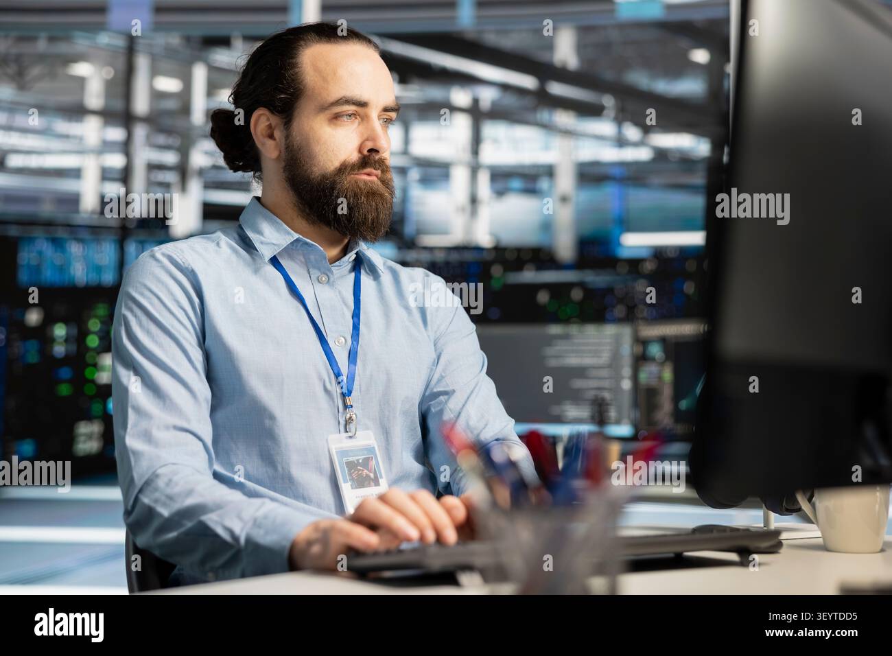 Data center engineer manages databases supporting AI applications and data mining in a server facility. Stock Photo
