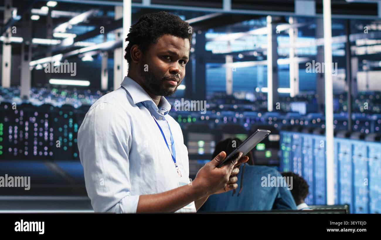 Data center technician uses node tree software to identify equipment performance issues and data patterns. Stock Photo