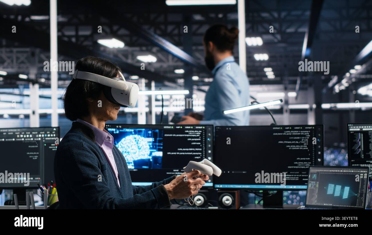 Data center engineer uses a VR headset to review AI diagnostics and manage server system performance. Stock Photo