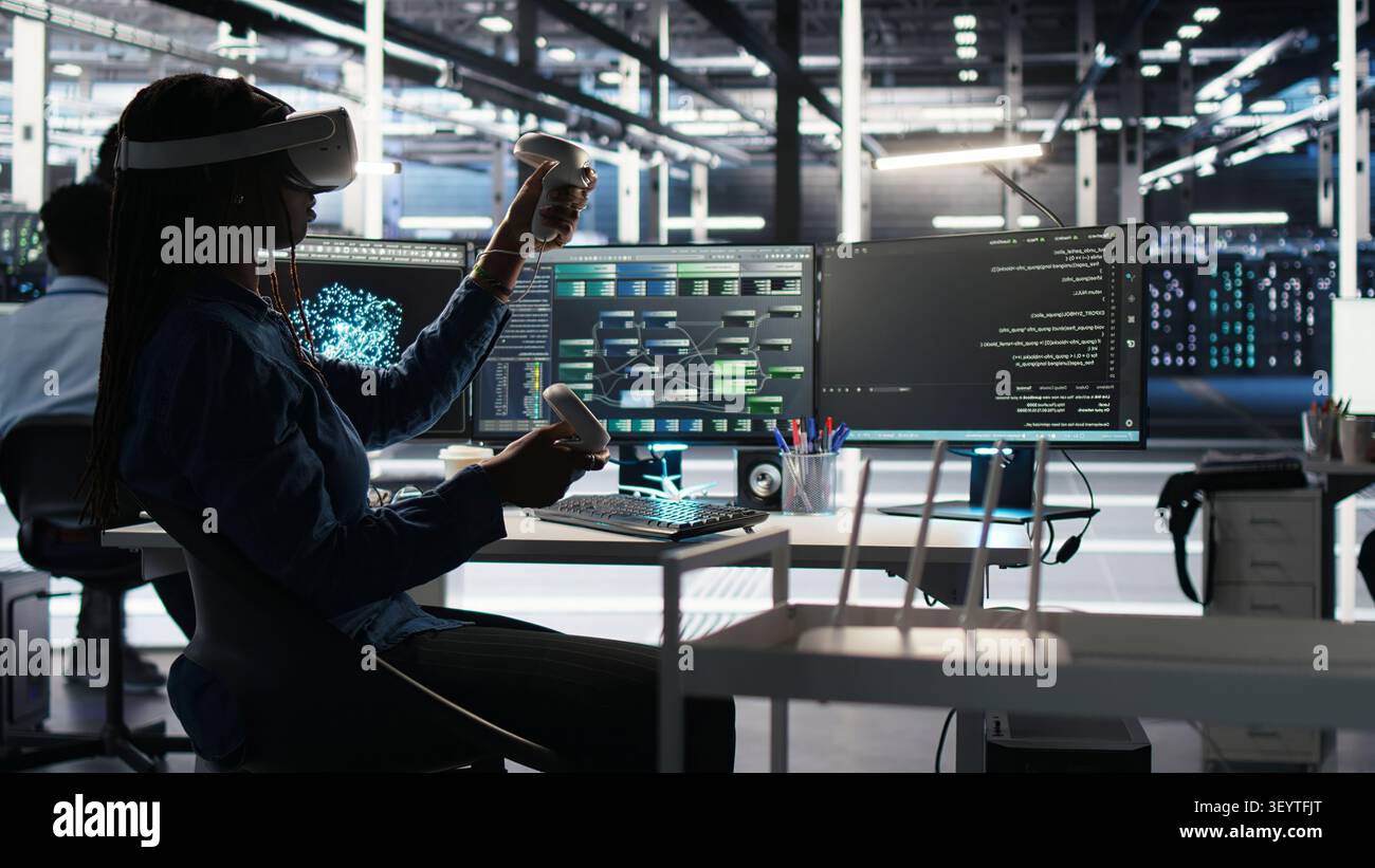Administrator wears a headset in a server farm, using artificial intelligence troubleshooting to assist users. Stock Photo