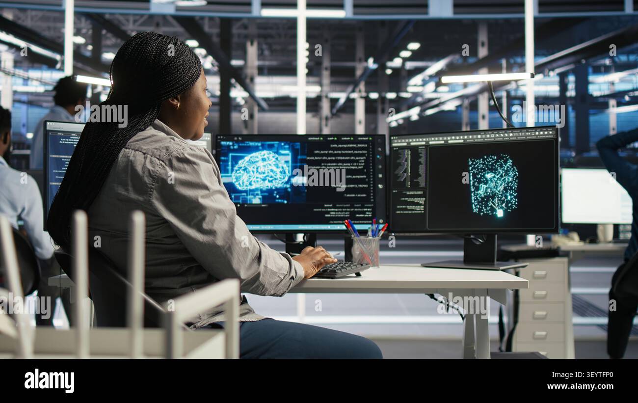 Server facility computing specialist applying AI ML models to set up hardware. IT specialist working with AI programming languages on workstation in server environment, optimizing system. Stock Photo