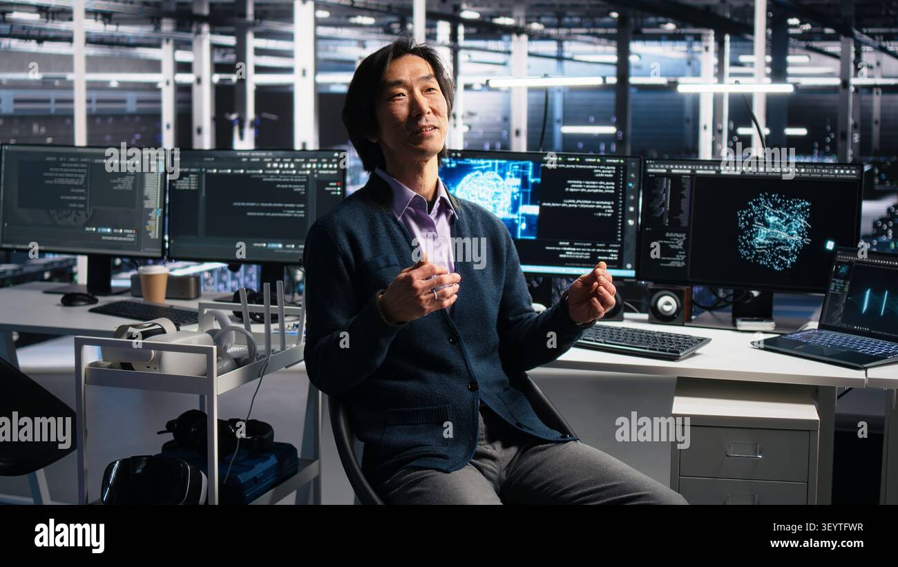 Smiling server room manager filming presentation, showcasing equipment working with AI tech. Stock Photo