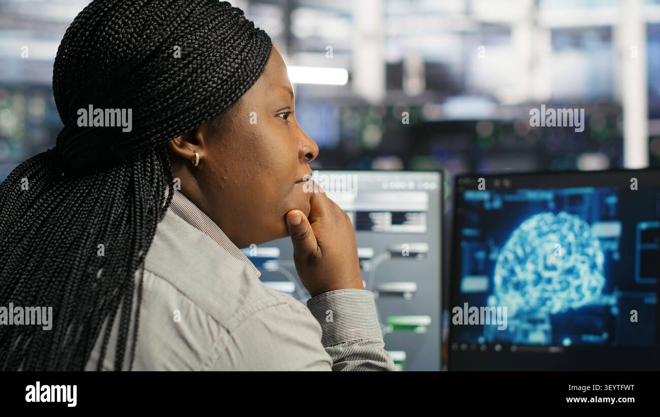 Server facility computing specialist applying AI ML models to set up hardware. IT specialist working with AI programming languages on workstation in server environment, optimizing system. Stock Photo