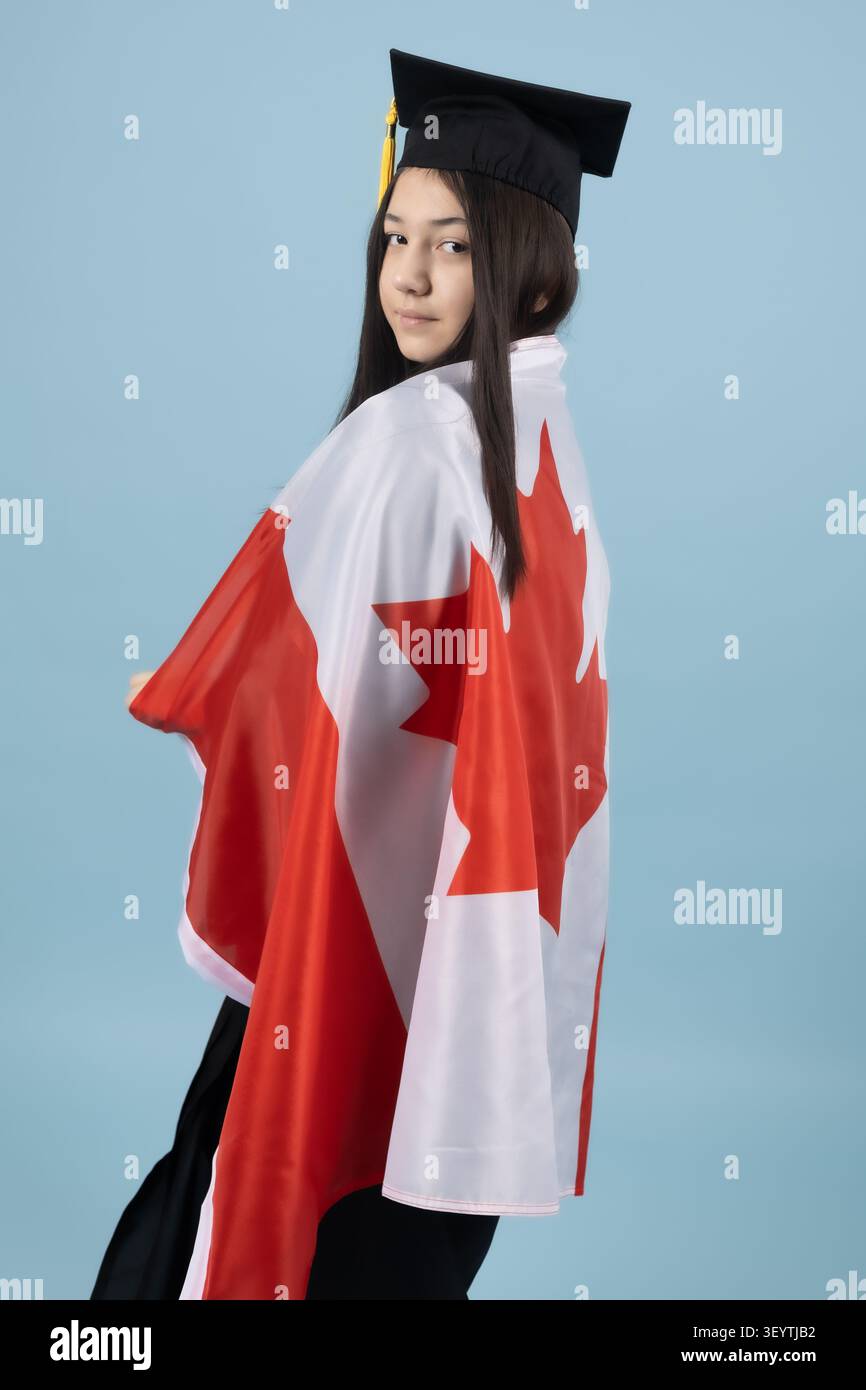 Proud graduate student holding a national flag celebrating success Stock Photo
