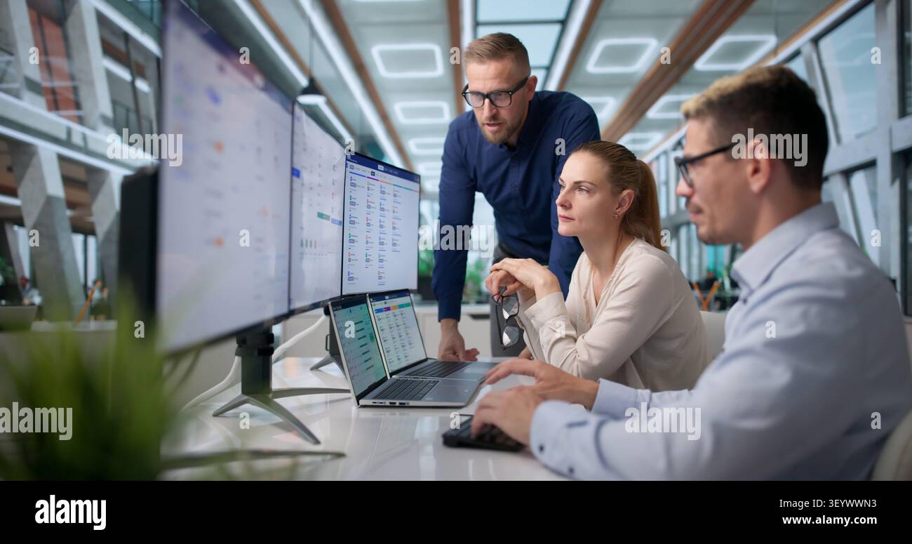 Human Resources Manager Leads Diverse Team Reviewing Payroll Software Features. Stock Photo