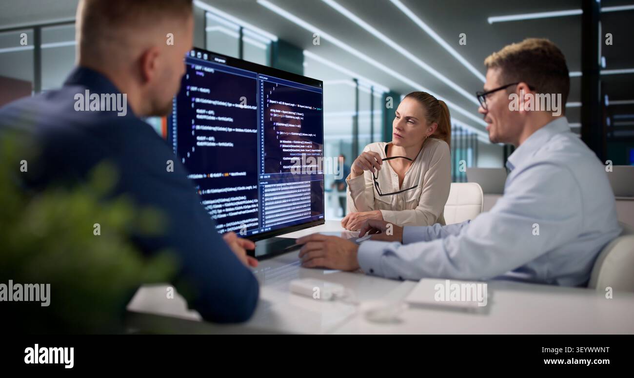 Diverse Team Of Software Engineers Collaborating On Secure Coding Projects. Stock Photo
