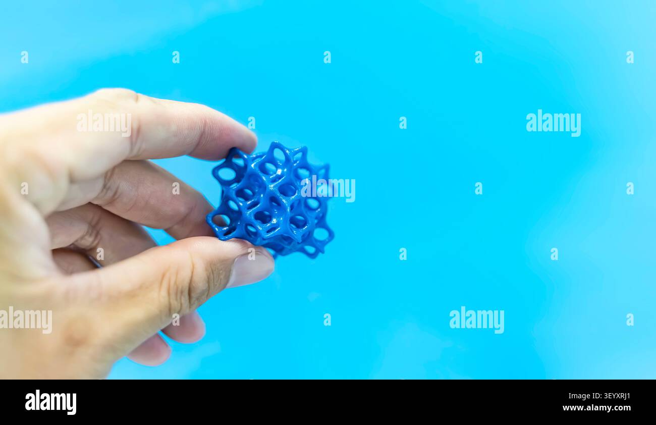 hand with flexible object printed on 3d printer close-up Stock Photo