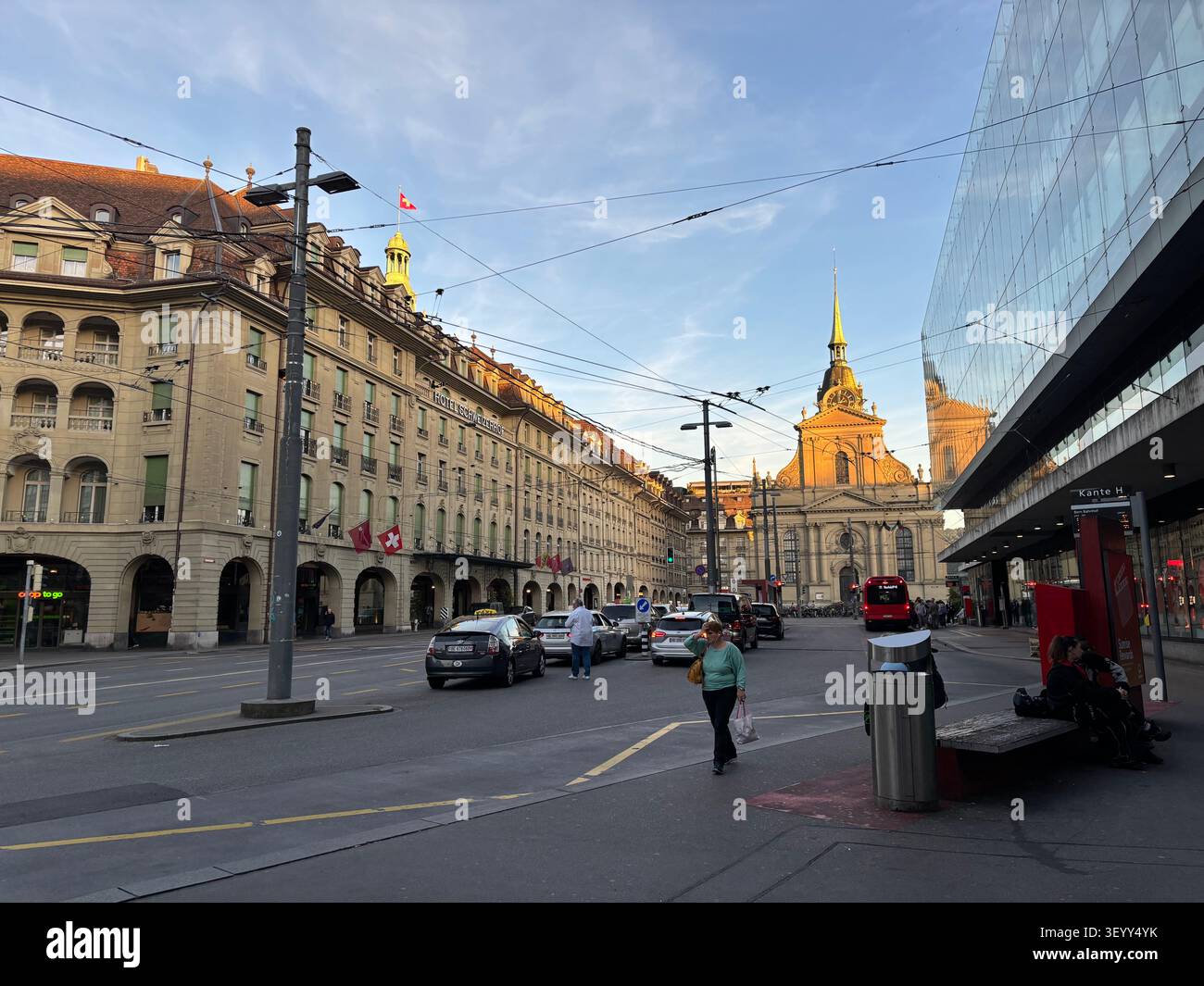 City life on the streets near the main train station with the Church of the Holy Ghost in the background, Bern, Switzerland - Smartphone Captured Stock Image