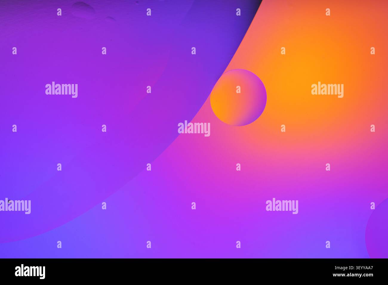 Oil bubbles creating an abstract purple and orange gradient texture background Stock Photo