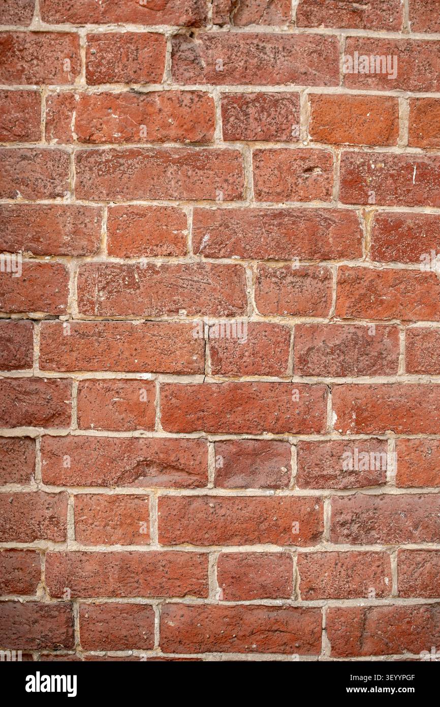 Aged red brick wall texture vertical pattern background Stock Photo