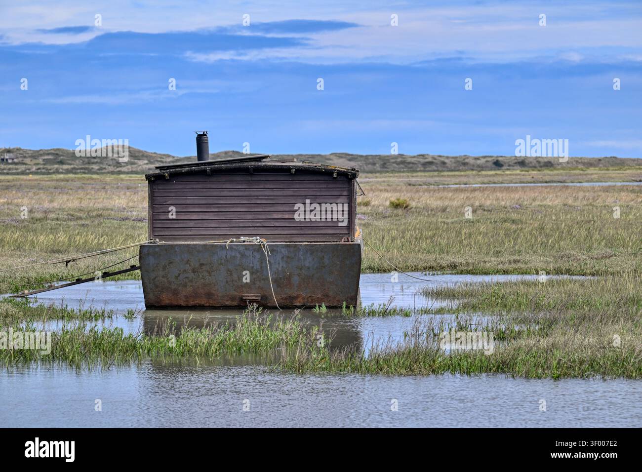 Old houseboat on the marshes at Burnham Deepdale near Brancaster, Norfolk, UK Stock Photo