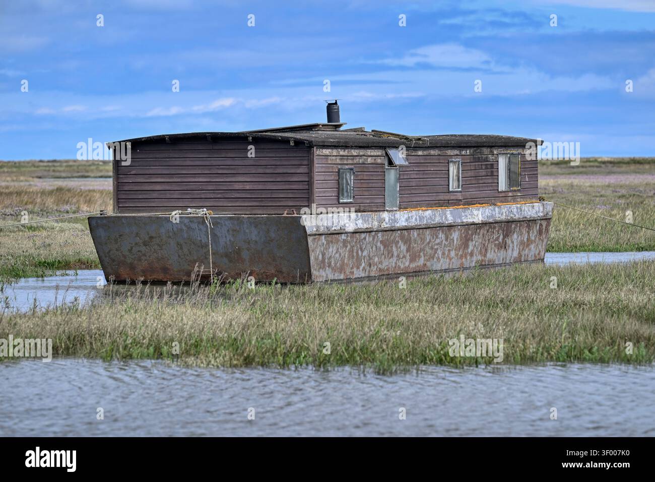 Old houseboat on the marshes at Burnham Deepdale near Brancaster, Norfolk, UK Stock Photo