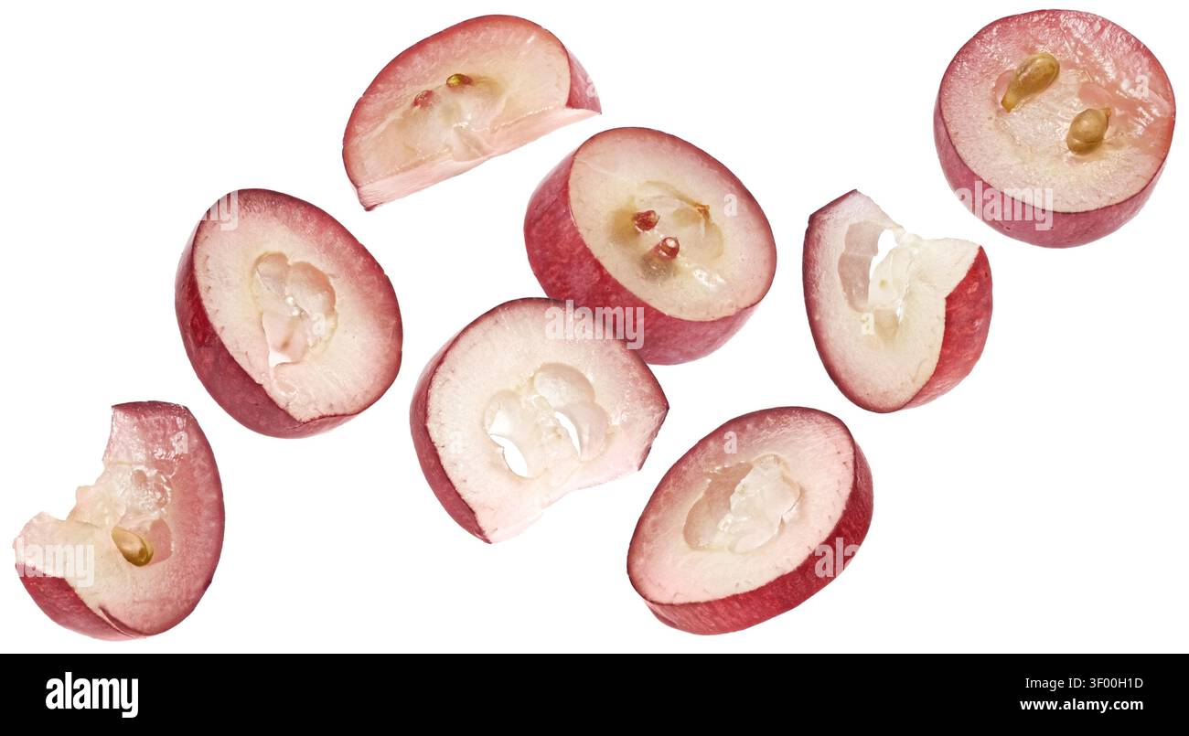 Falling red grape slices isolated on white background Stock Photo
