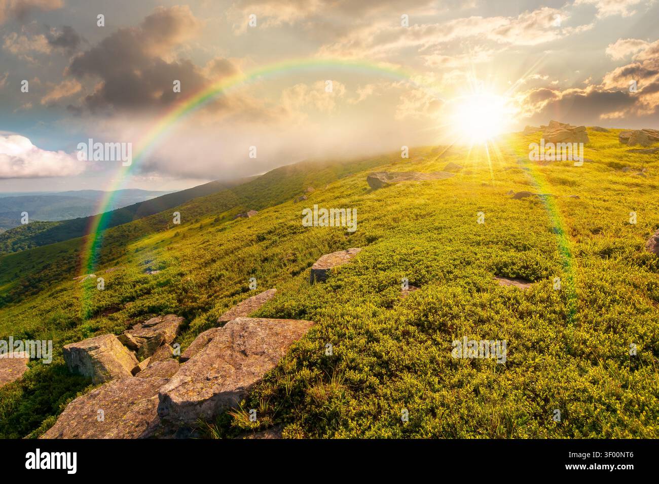 sunset over nature scenery with mountain under summer sky. alpine landscape of carpathian mountain with grassy slopes. low fluffy clouds on high altit Stock Photo