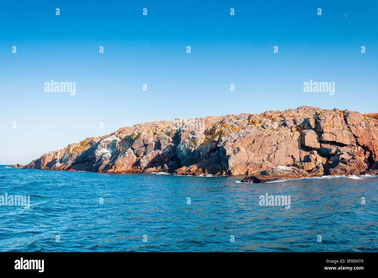 sea coast of bulgaria. travel background for summer vacations in europe. rock shore of st. peter island in evening light Stock Photo