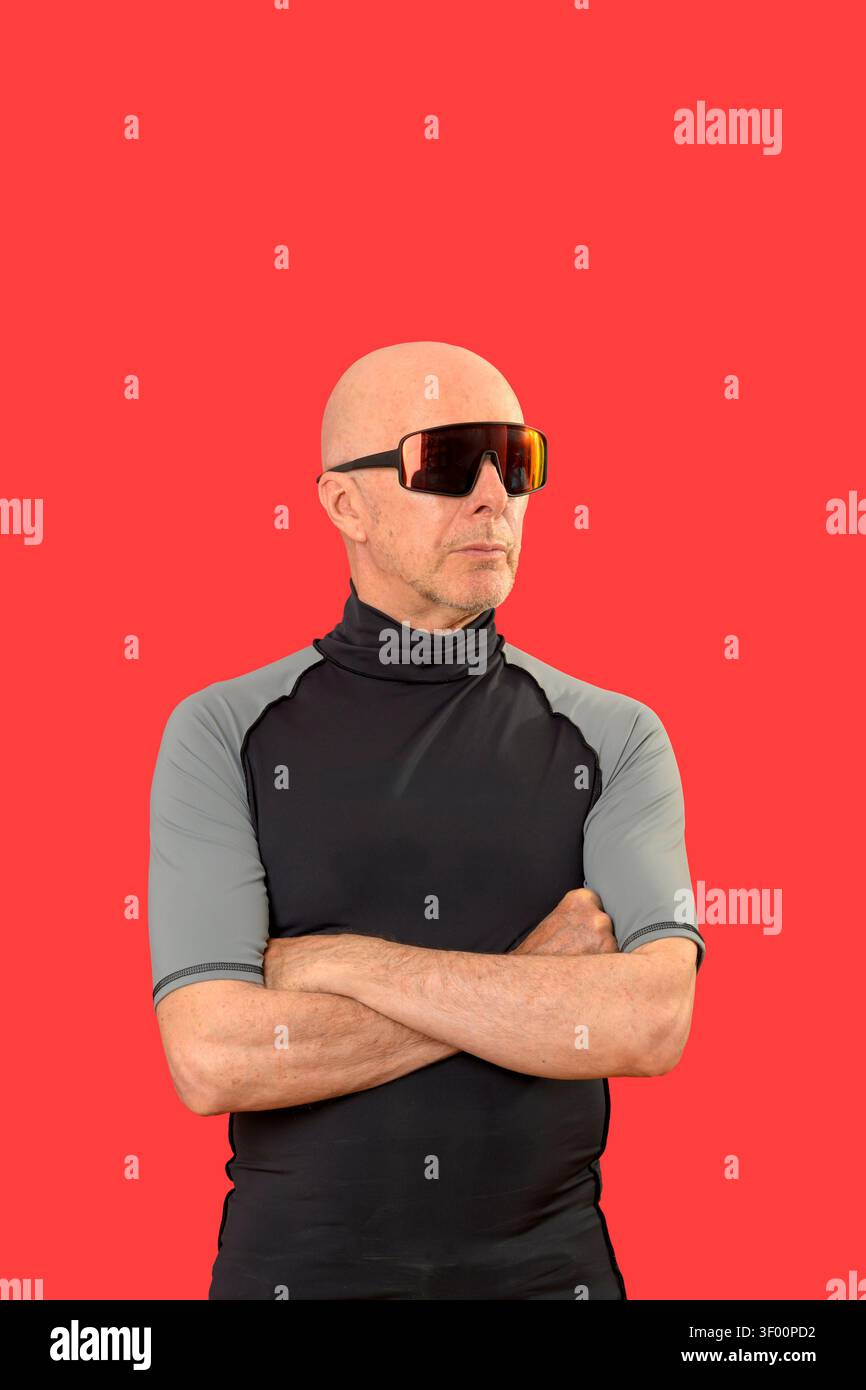 sporty bald man standing with arms folded Stock Photo