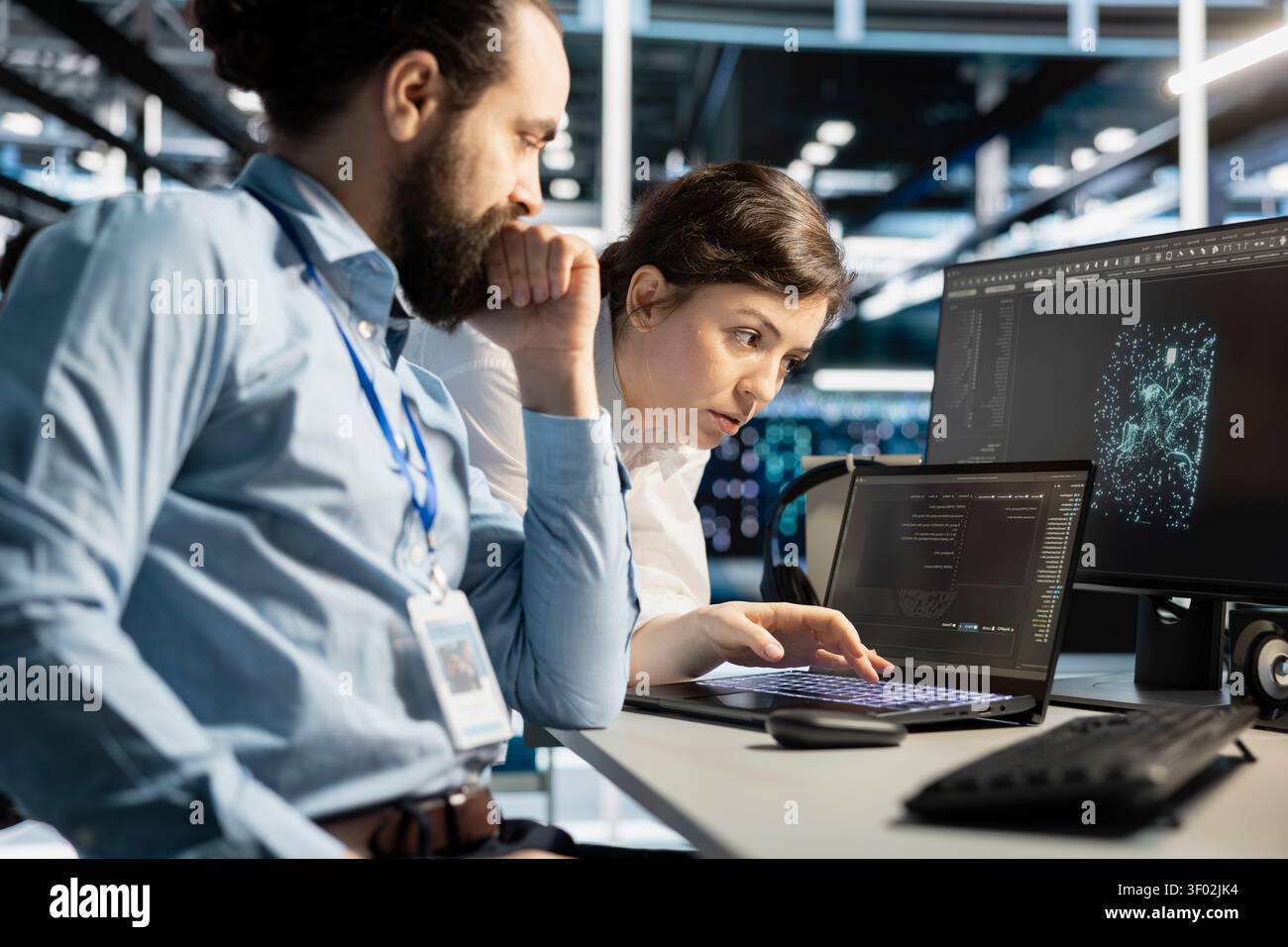Data center colleagues collaborate on coding and AI automation scripts while reviewing server infrastructure together. Stock Photo