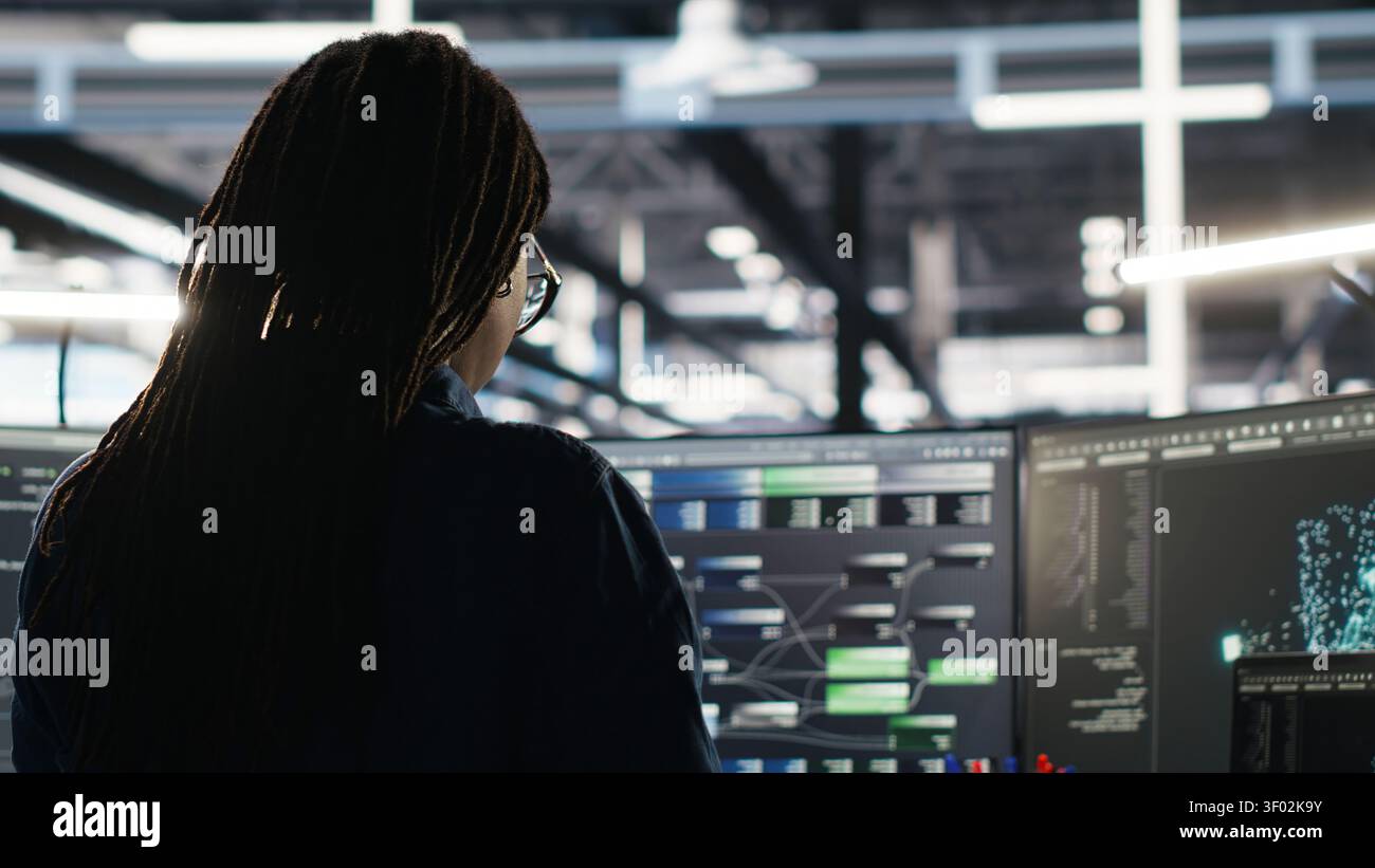 System administrator reviews node tree software to analyze datasets and improve server infrastructure performance. Stock Photo