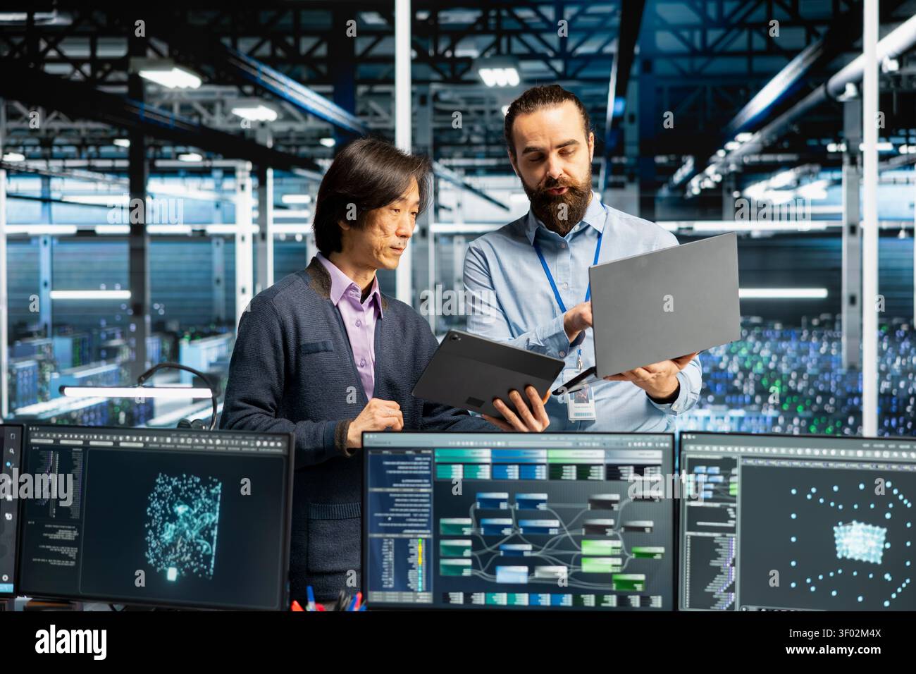 Engineers coding in data infrastructure center, updating AI driven automation scripts, while IT staff members working in server facility programming AI algorithms, debugging equipment. Stock Photo