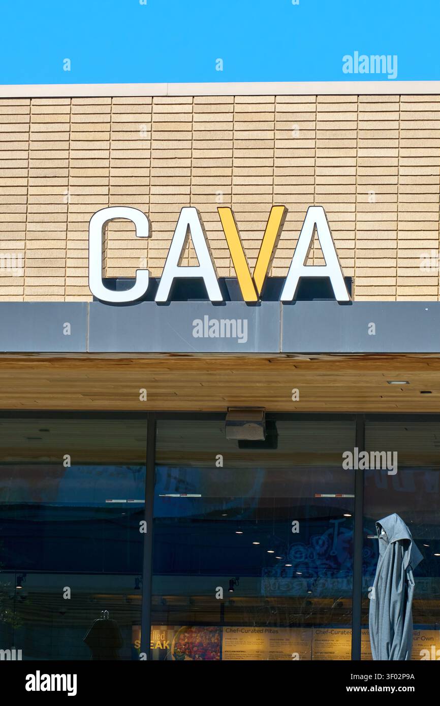 DALLAS, TX, USA - FEBRUARY 16, 2024: The front of a CAVA restaurant in Dallas displays a prominent sign on a tan brick facade. CAVA, known for its fas Stock Photo