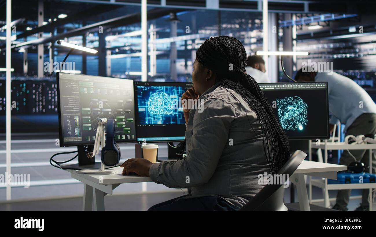 Server facility software engineer applying AI ML models to set up hardware. IT professional works on AI programming tools in server environment, optimizing system. Stock Photo