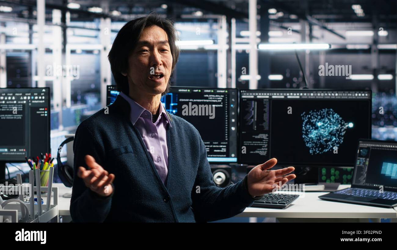 Smiling server room manager filming presentation, showcasing equipment working with AI tech. Stock Photo