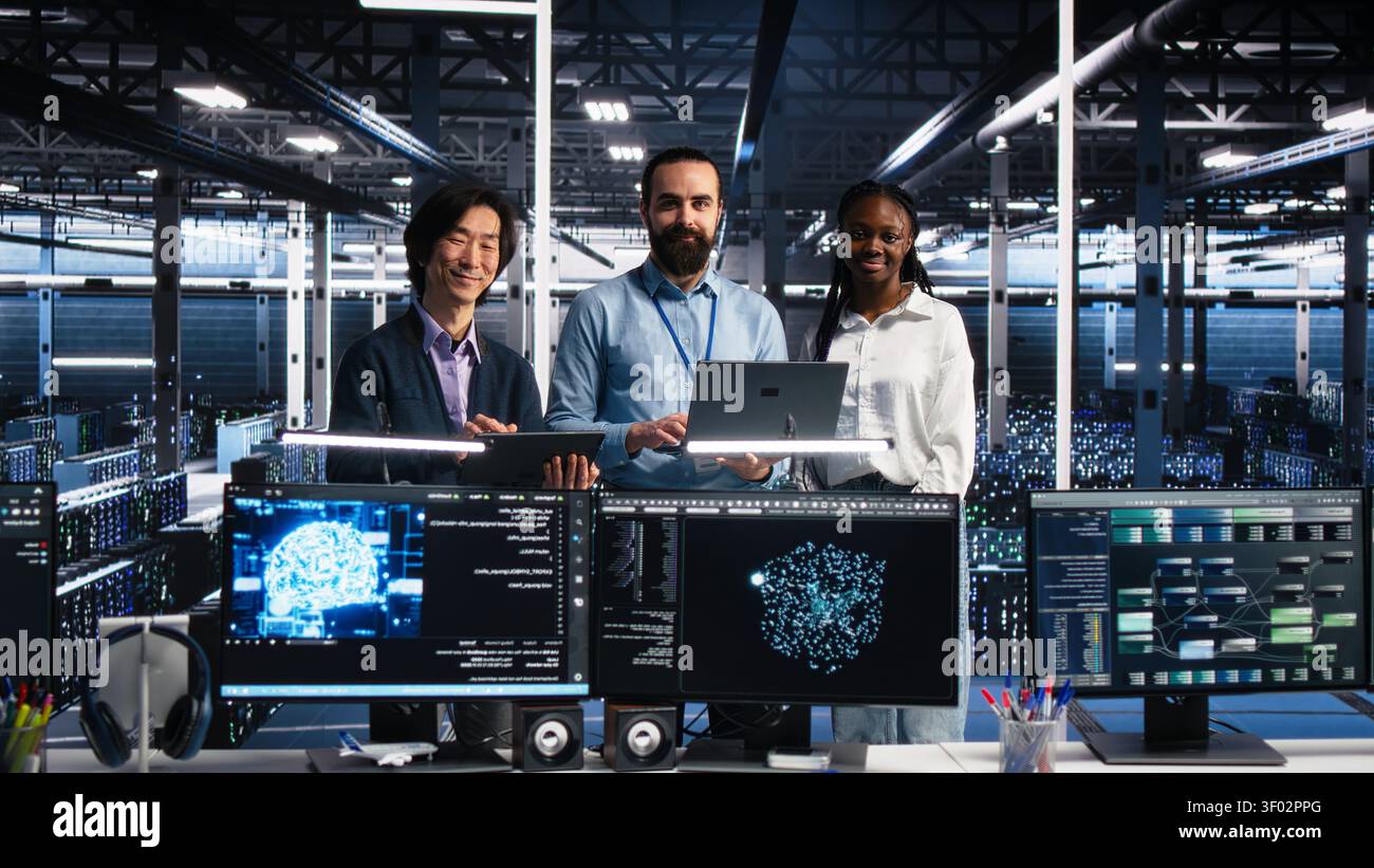 Engineers program on a computer workstation in a data center with generative AI assistance. Stock Photo