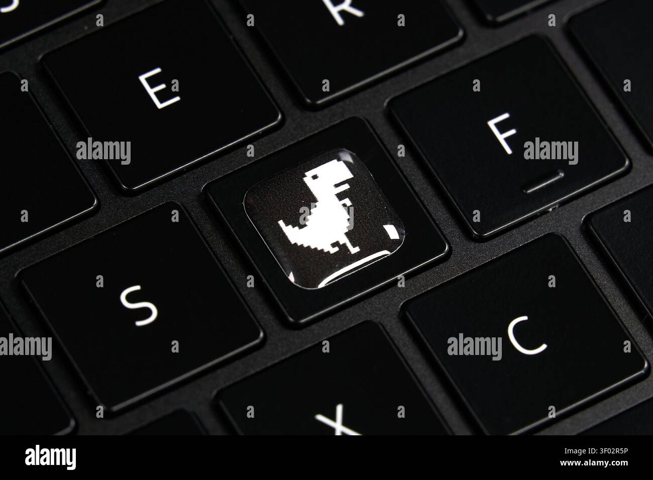 DALLAS, TX, USA - FEBRUARY 16, 2024: A black keyboard features a unique keycap replacing the usual character with an illustration of the iconic Chrome Stock Photo
