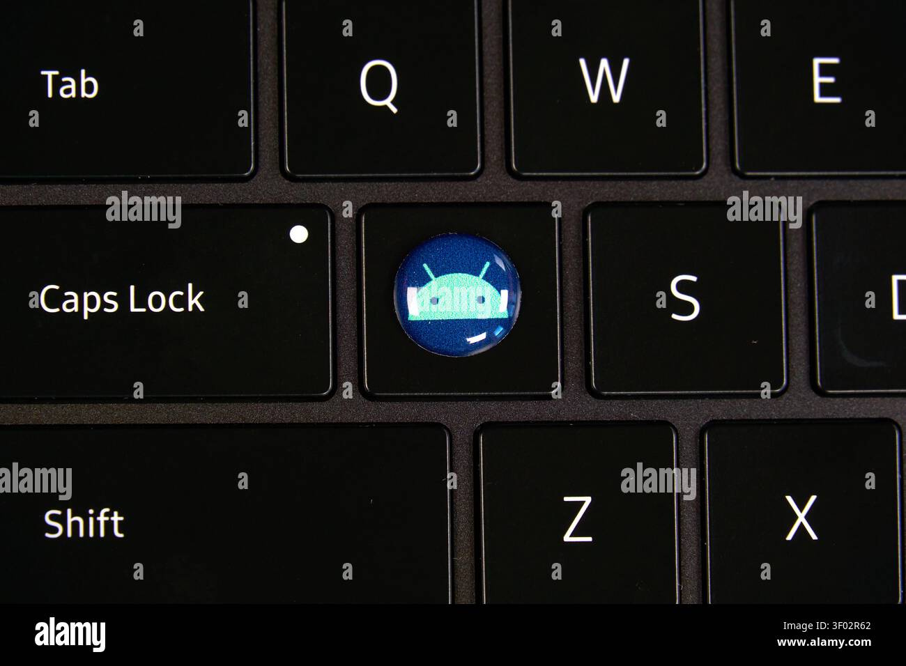 DALLAS, TX, USA - FEBRUARY 16, 2024: A close-up image showing a black keyboard with a special key featuring the Android logo. The design replaces a st Stock Photo