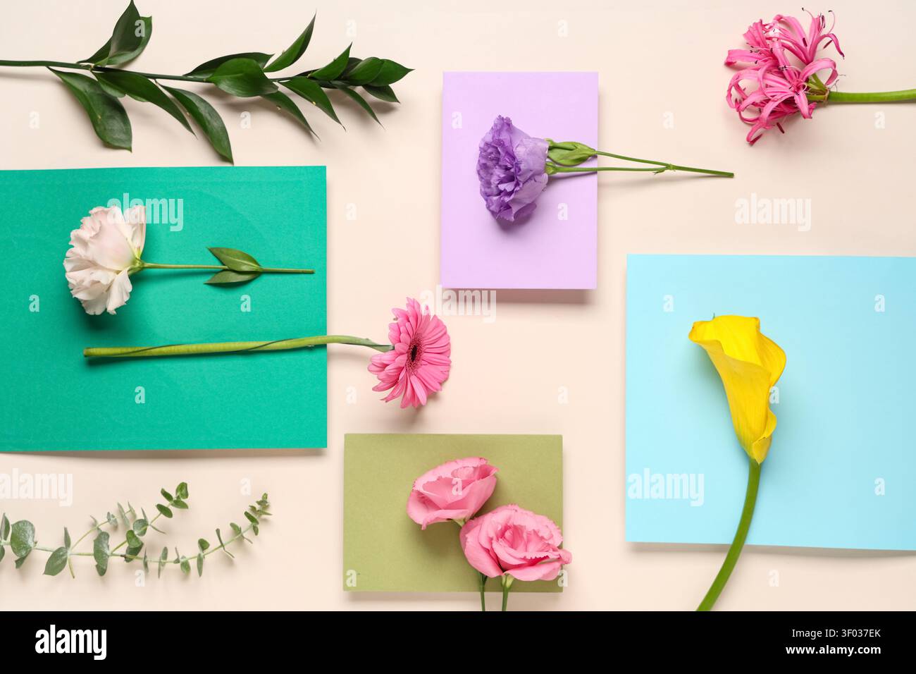 Composition with envelopes and different flowers on beige background Stock Photo