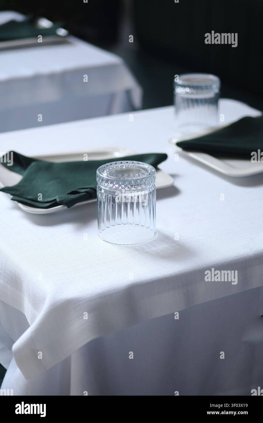 Table set for dining in a restaurant at evening time Stock Photo