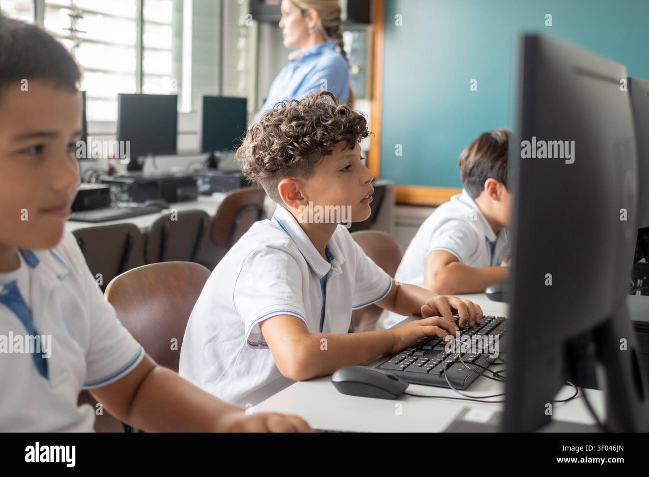 Elementary School Boys Using Desktop Computers During an Information Technology Class Stock Photo
