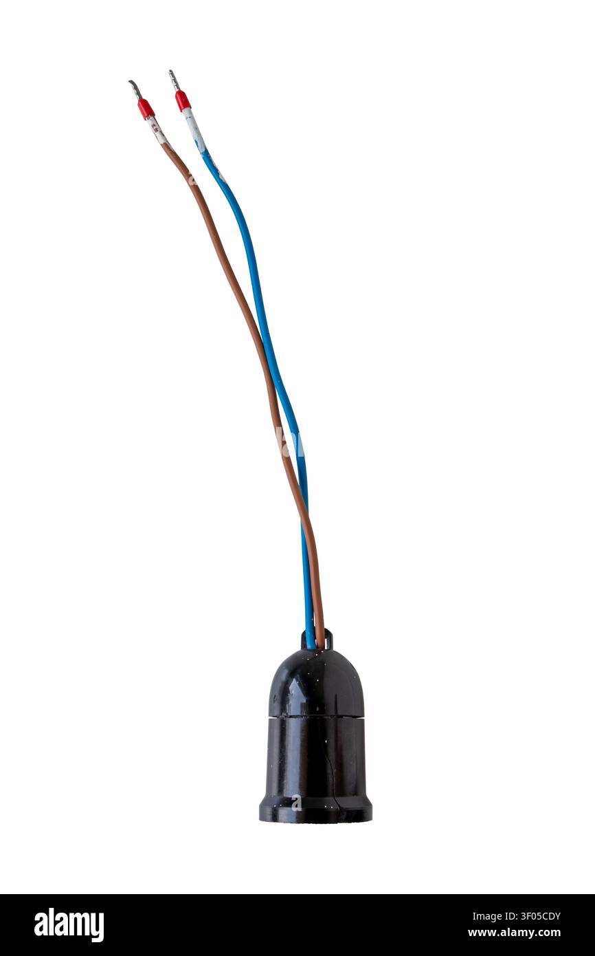 Old used black plastic light bulb socket with cracks, white paint splashes and exposed blue and brown wires, isolated on white background. Stock Photo