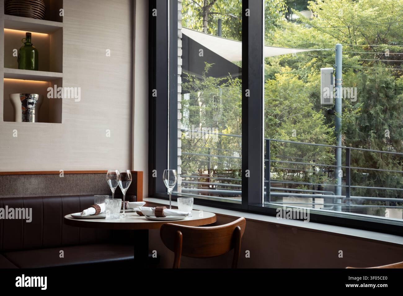 Elegant Table Setting by the Window in a Modern Restaurant Stock Photo
